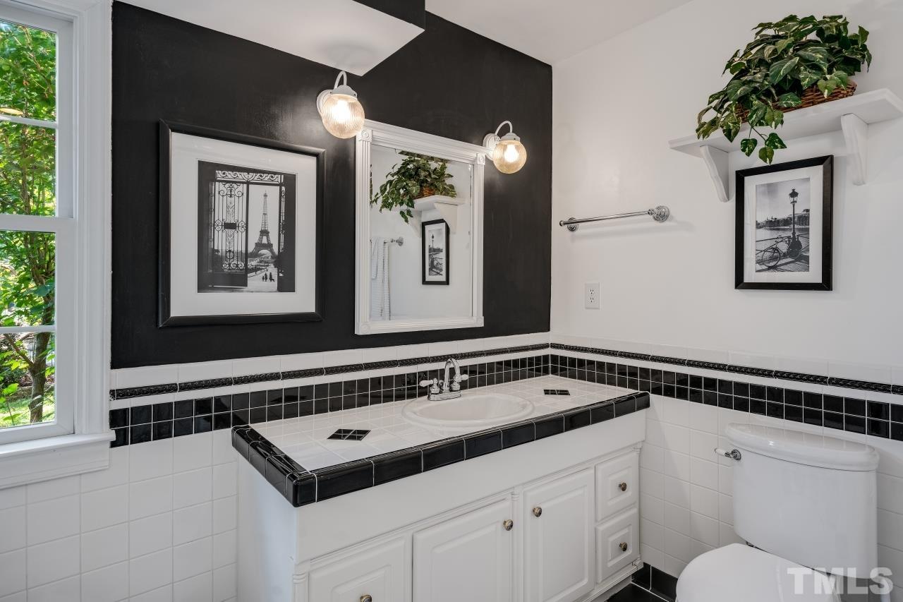 4108 Pleasant Grove Church Road Raleigh, NC 27613 - Photo 13 of 30 a view of a hallway that has a dresser and chair