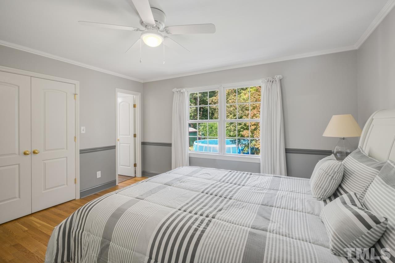 4108 Pleasant Grove Church Road Raleigh, NC 27613 - Photo 17 of 30 a bedroom with a bed and a lamp