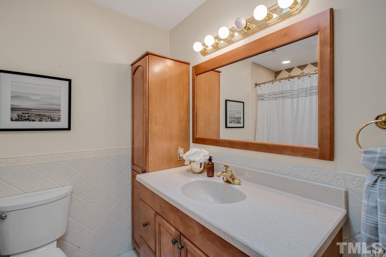 4108 Pleasant Grove Church Road Raleigh, NC 27613 - Photo 19 of 30 a bathroom with a sink vanity and a mirror