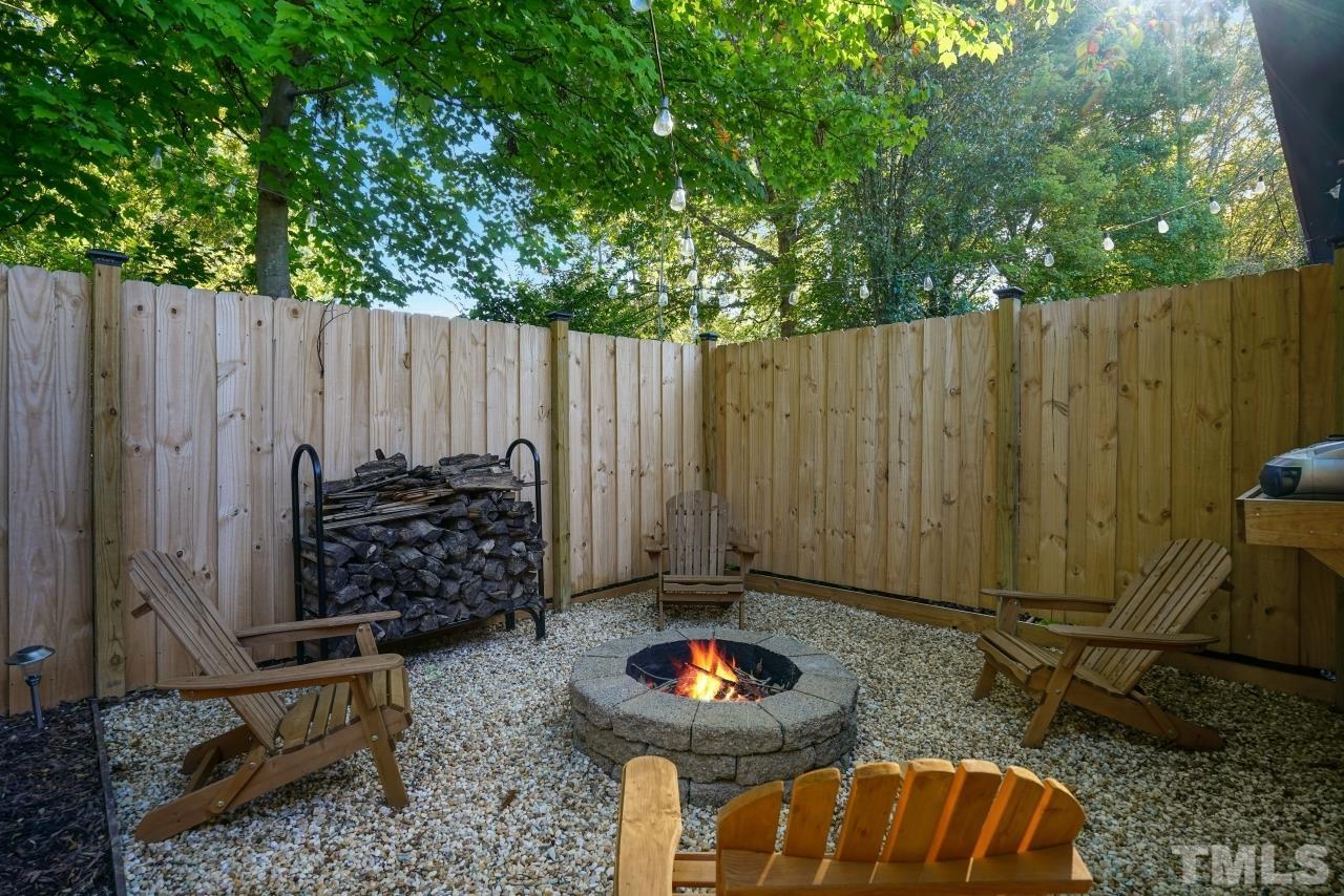 4108 Pleasant Grove Church Road Raleigh, NC 27613 - Photo 22 of 30 a backyard of a house with barbeque oven and trees