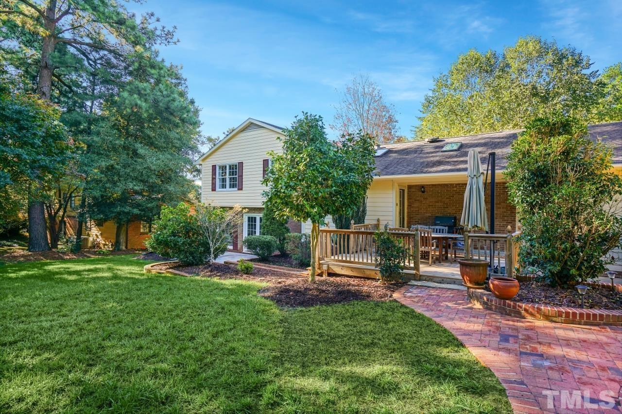 4108 Pleasant Grove Church Road Raleigh, NC 27613 - Photo 26 of 30 a view of a house with backyard sitting area and garden