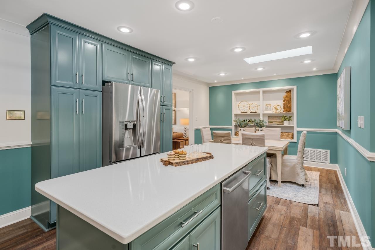 4108 Pleasant Grove Church Road Raleigh, NC 27613 - Photo 4 of 30 a kitchen with a sink a refrigerator and wooden floor