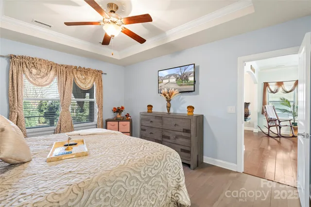 a bedroom with a bed and a chandelier