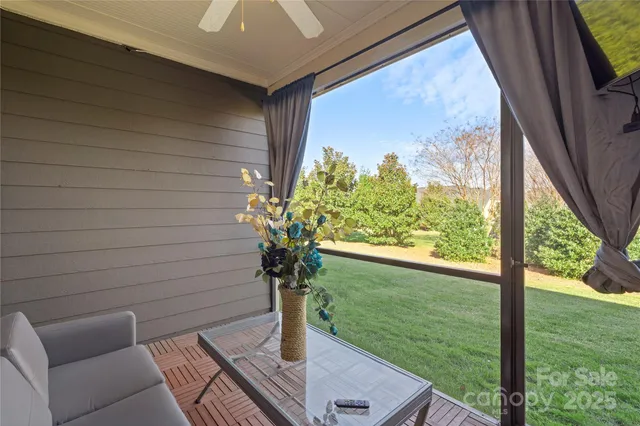 a vase with flowers sitting on a table in front of a window
