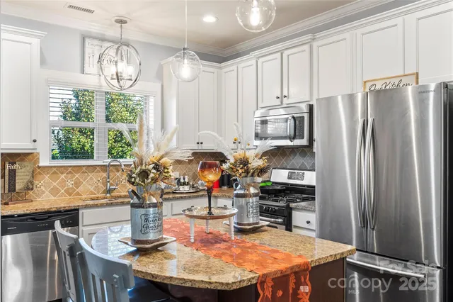 a kitchen with refrigerator a stove and a sink