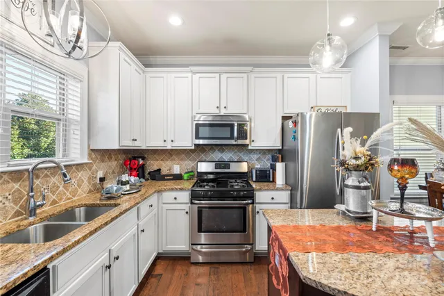 a very nice looking dining room with a table and chairs