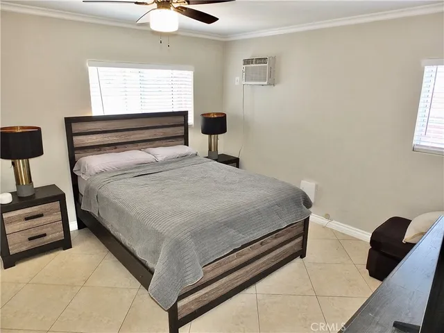 a bedroom with furniture and flat screen tv