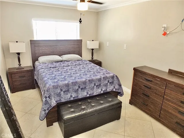 a bedroom with a bed and a mirror