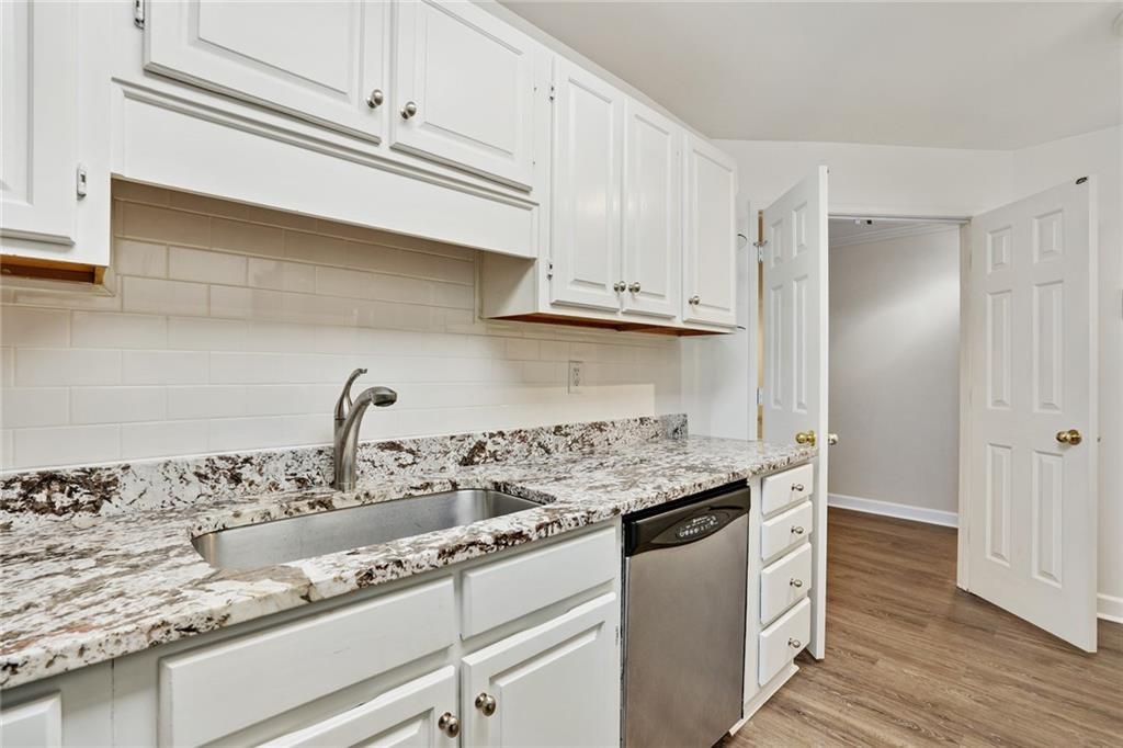 3203 Lenox Road Northeast, Unit 6 Atlanta, GA 30324 - Photo 7 of 27 a kitchen with granite countertop stainless steel appliances a sink and cabinets