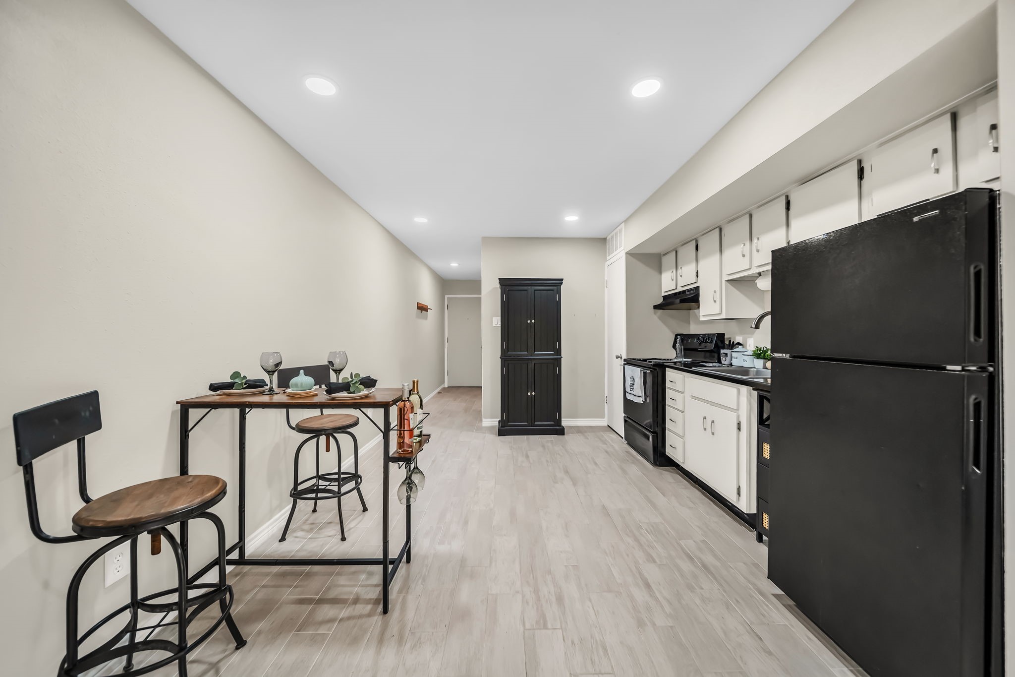 12900 Walden Road, Unit 505 Montgomery, TX 77356 - Photo 12 of 50 a kitchen with stainless steel appliances a refrigerator a stove a sink dishwasher and a refrigerator with wooden floor