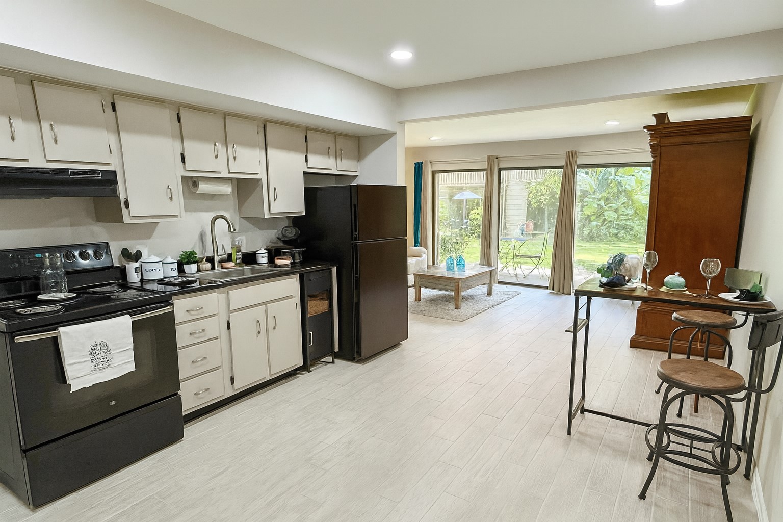 12900 Walden Road, Unit 505 Montgomery, TX 77356 - Photo 14 of 50 a kitchen with stainless steel appliances granite countertop a refrigerator a sink a stove and white cabinets with wooden floor