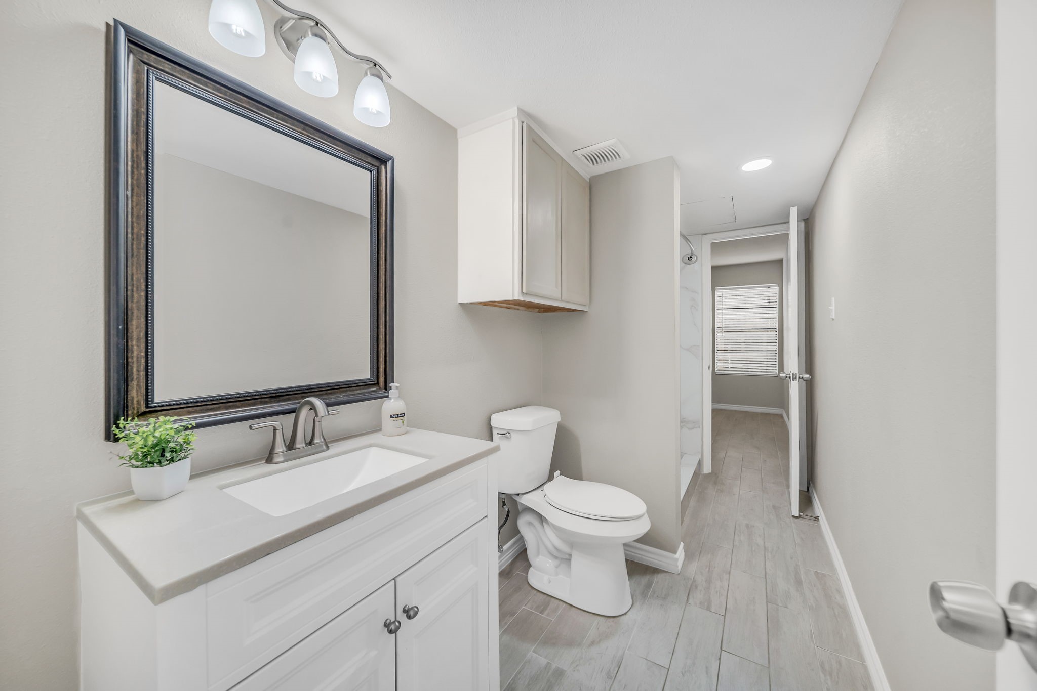 12900 Walden Road, Unit 505 Montgomery, TX 77356 - Photo 17 of 50 a bathroom with a toilet sink and mirror