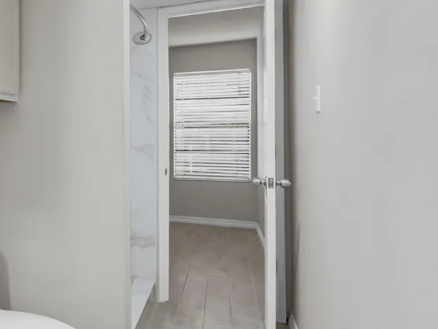 a view of an empty room with a window