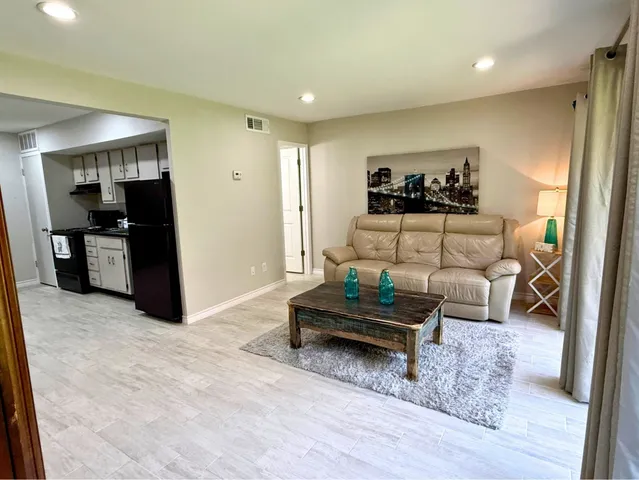 a view of a house with a yard patio and fire pit