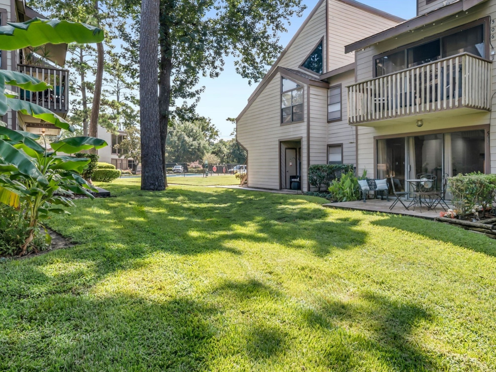 12900 Walden Road, Unit 505 Montgomery, TX 77356 - Photo 31 of 50 a view of a house with a yard patio and fire pit