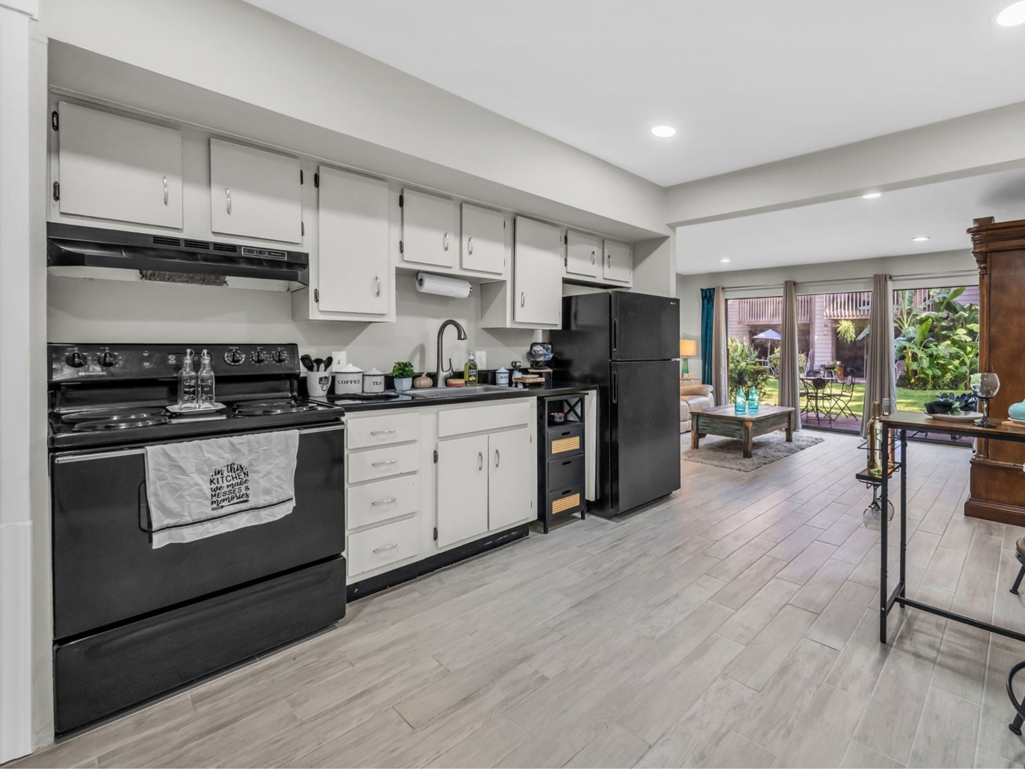 12900 Walden Road, Unit 505 Montgomery, TX 77356 - Photo 9 of 50 a kitchen with stainless steel appliances a stove sink refrigerator and cabinets