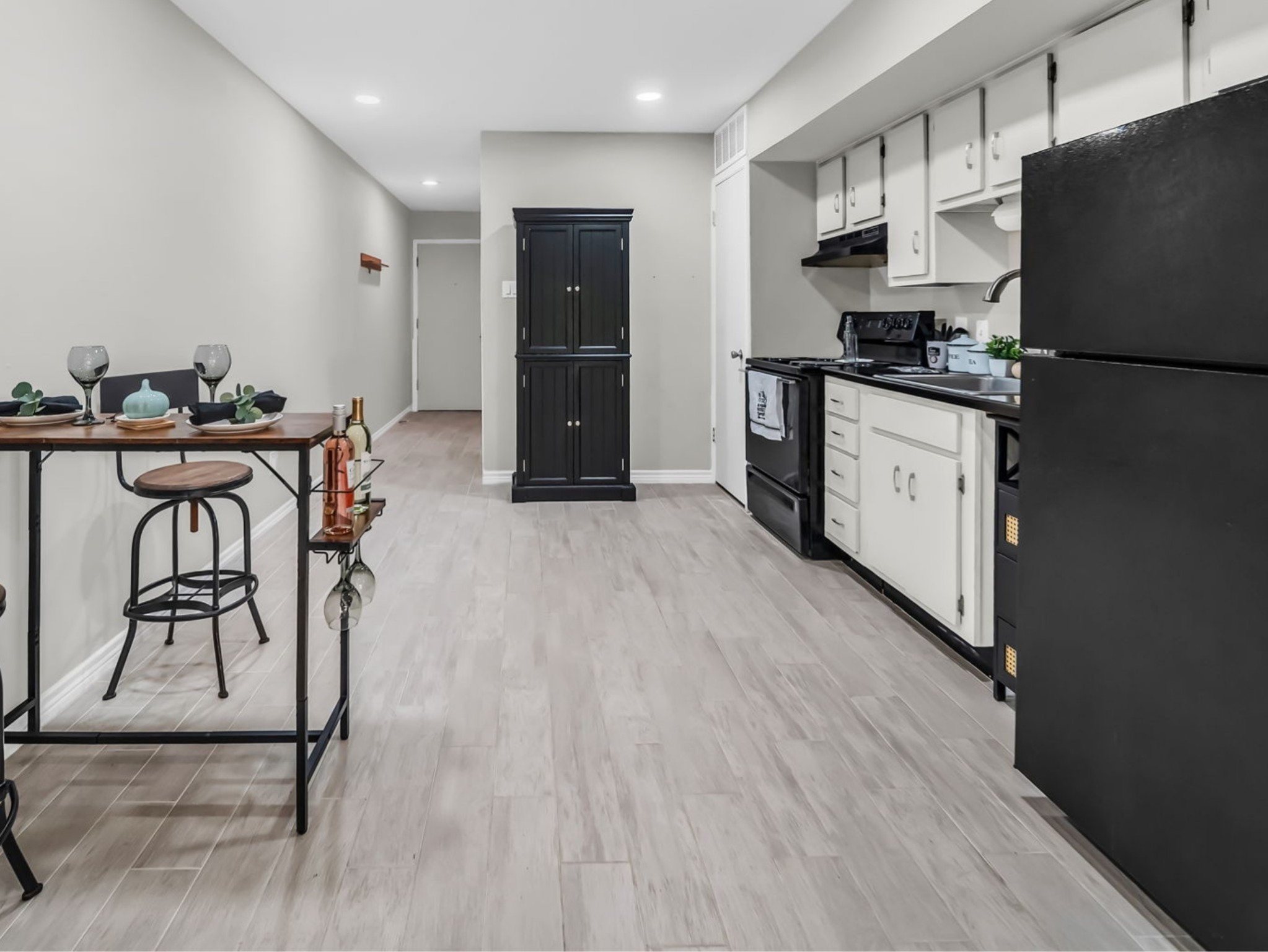 12900 Walden Road, Unit 505 Montgomery, TX 77356 - Photo 10 of 50 a kitchen with stainless steel appliances granite countertop a refrigerator a stove a sink dishwasher and a refrigerator with wooden floor