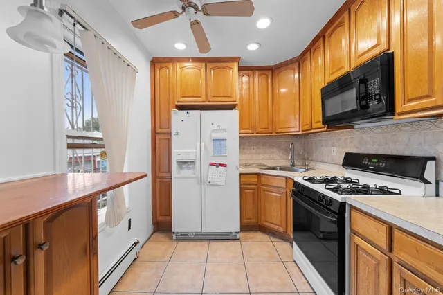 a kitchen with stainless steel appliances granite countertop a stove a refrigerator and a microwave