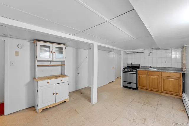 a kitchen with granite countertop a stove top oven and sink