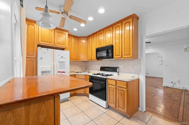 a kitchen with stainless steel appliances granite countertop wooden cabinets a stove top oven a sink and dishwasher