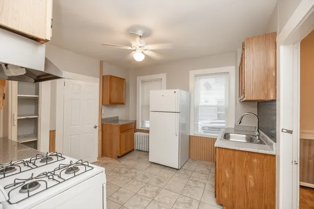 a kitchen with a refrigerator and a sink