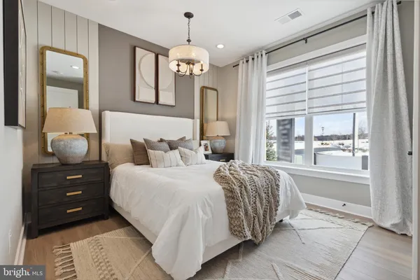 a bedroom with a bed and a painting on the wall