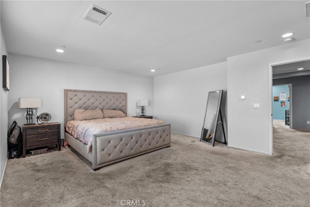 6949 Beale Road Palmdale, CA 93552 - Photo 21 of 32 a spacious bedroom with a bed and a couch