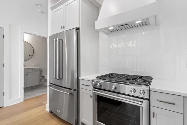 a kitchen with a stove and a refrigerator