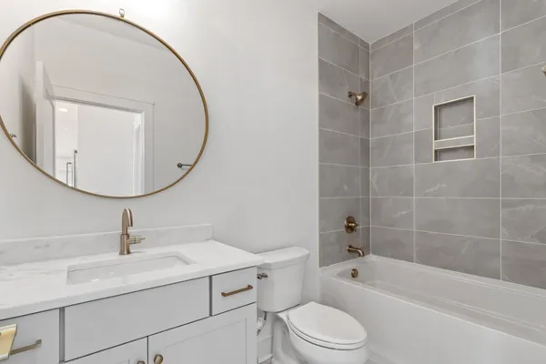 a bathroom with a sink a toilet and a mirror