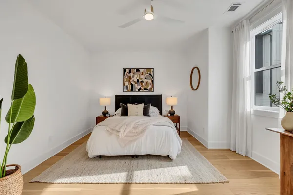 a bedroom with a bed and a painting on the wall
