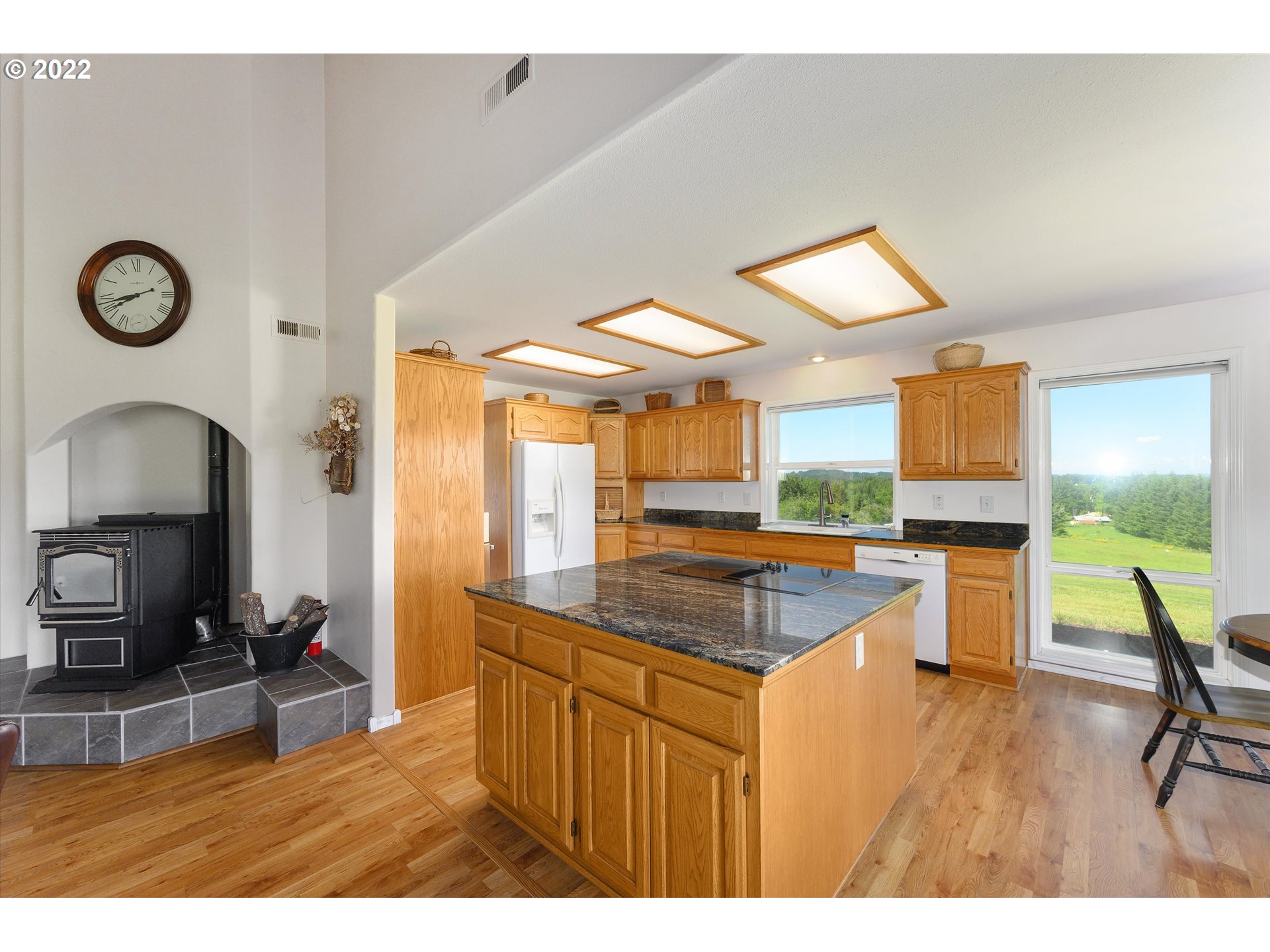 16750 Oakdale Road Dallas, OR 97338 - Photo 9 of 32 a kitchen with stainless steel appliances granite countertop a stove a sink dishwasher and a dining table with the kitchen view