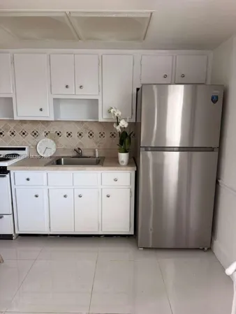 a view of a house with a wooden fence