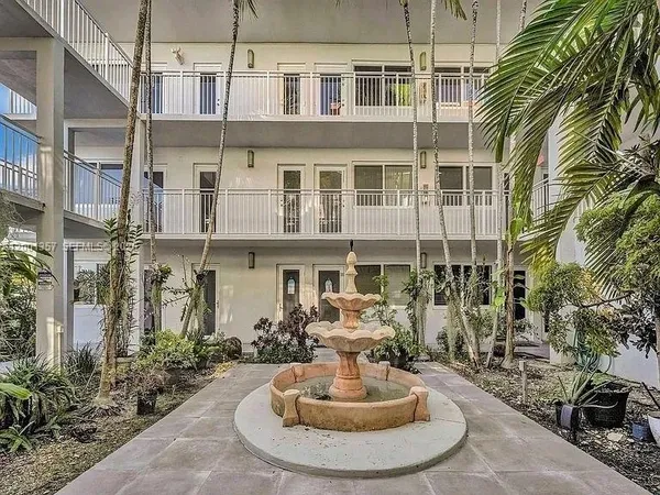 a view of a ocean with boats and trees in the background