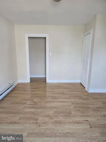 a view of an empty room and wooden floor