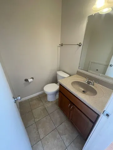 a bathroom with a sink toilet and mirror