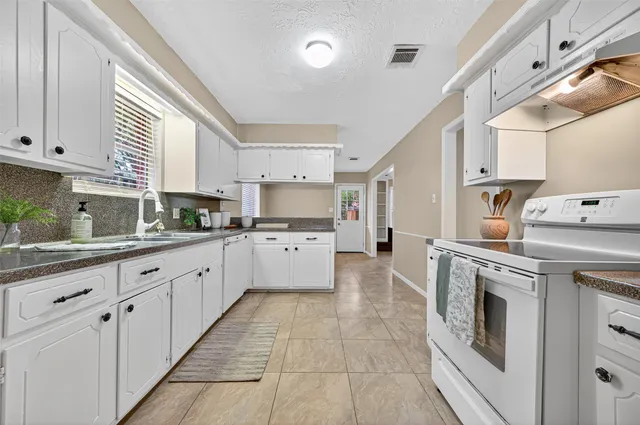 a kitchen with cabinets and window