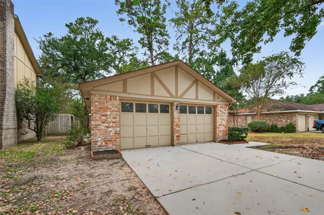a white house that has a tree in front of it