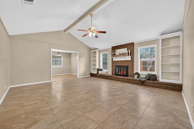 an empty room with furniture and a fireplace
