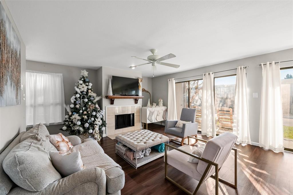 a living room with furniture large window and a fireplace
