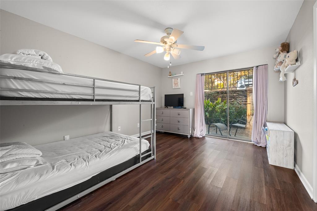 1031 Signal Ridge Place, Unit 1031 Rockwall, TX 75032 - Photo 9 of 20 a bedroom with a bed and glass door