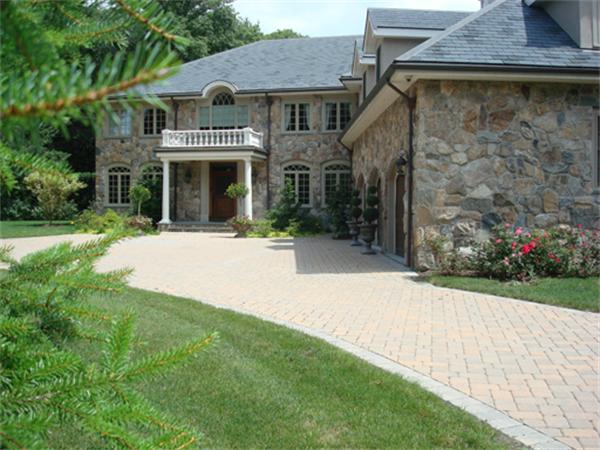 123 Cliff Road Wellesley, MA 02481 - Photo 1 of 1 a front view of a house with a yard and garage