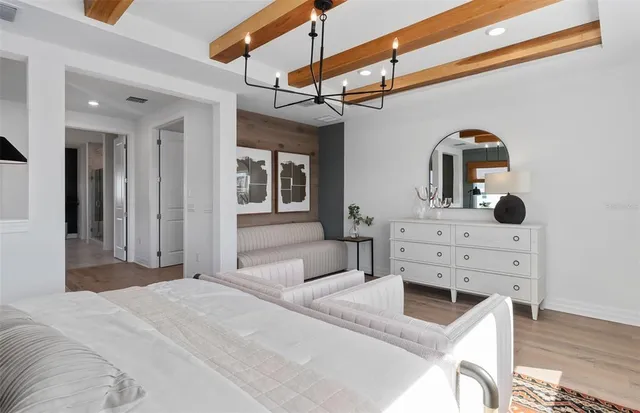 a living room with furniture a wooden floor and a large window