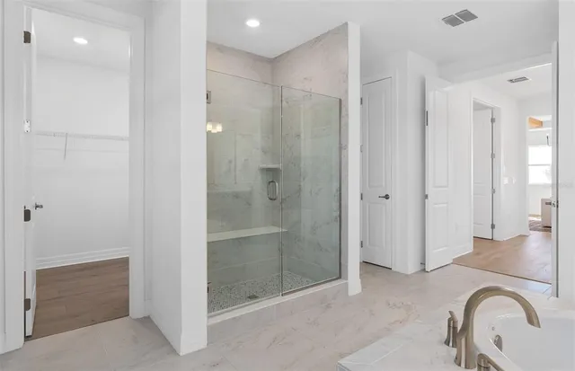 a view of a hallway with wooden floor