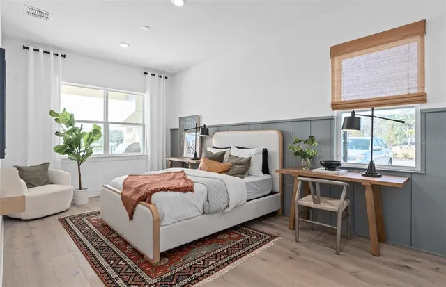 a bedroom with a bed and wooden floor