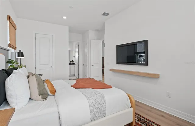 a bed room with a bed and a chandelier