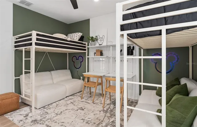 a bathroom with a granite countertop sink a toilet a mirror and shower