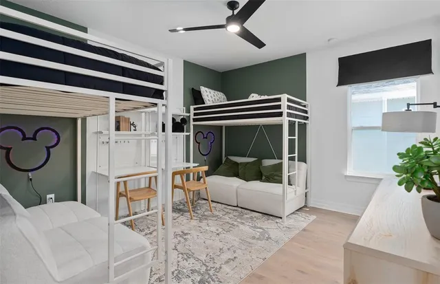 a bathroom with a granite countertop sink a toilet a mirror and shower