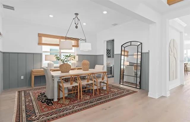 a kitchen with stainless steel appliances a sink a stove and a wooden floors