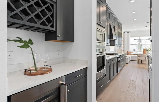 a view of entryway kitchen and hall with wooden floor