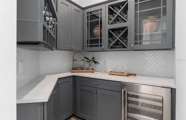 a kitchen with stainless steel appliances kitchen island granite countertop a table chairs sink and cabinets